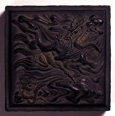 Ink-cake in seal form with a domed knop moulded in dramatic relief with two dragons among waves, attributed to Wang Wei-kao, Ching dynasty, Hui-chou, Anhui by Chinese School
